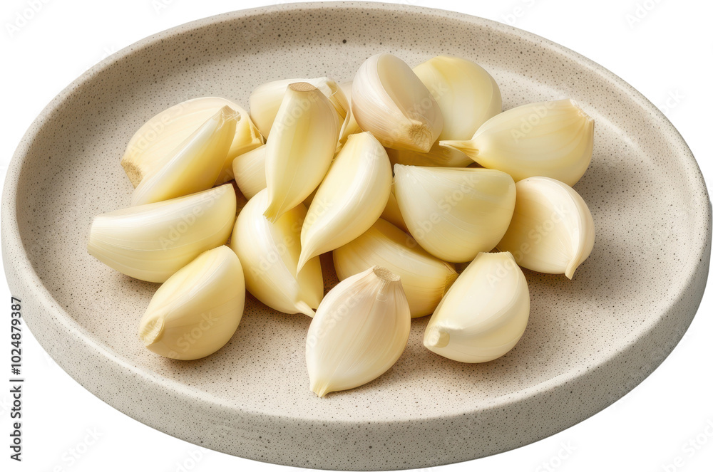 Fresh garlic cloves arranged on a neutral plate, showcasing their unique shape and natural color, ideal for culinary use. Fresh garlic cloves arranged on a neutral plate, showcasing their unique shape and natural color, ideal for culinary use.