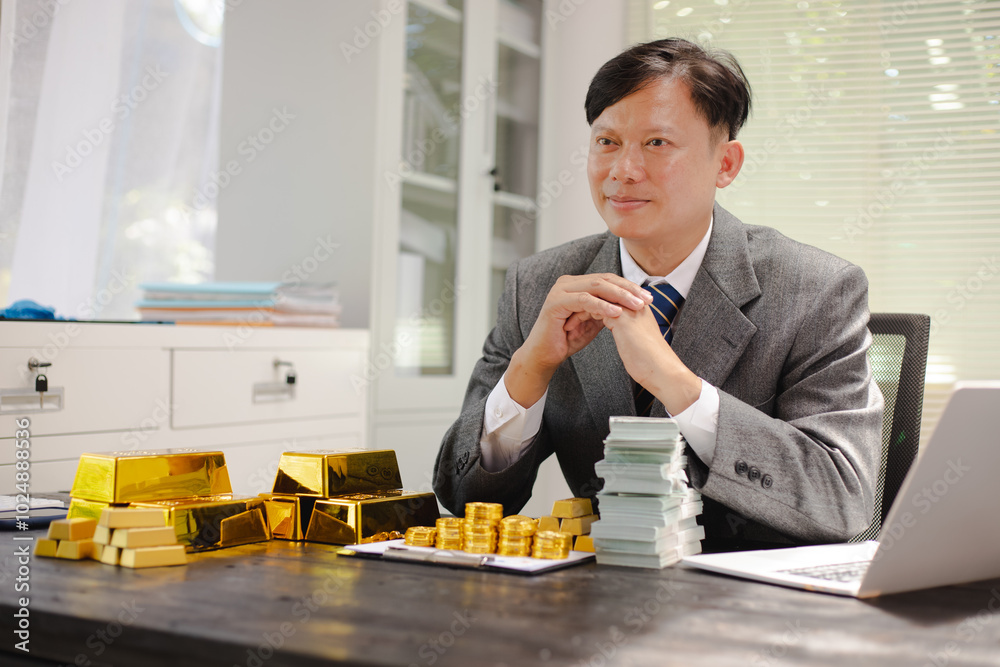 Businessman working hard with gold bars, assessing investments and transactions in finance office, wealth, asset allocation and precious metals trading strategies. Businessman working hard with gold bars, assessing investments and transactions in finance office, wealth, asset allocation and precious metals trading strategies.