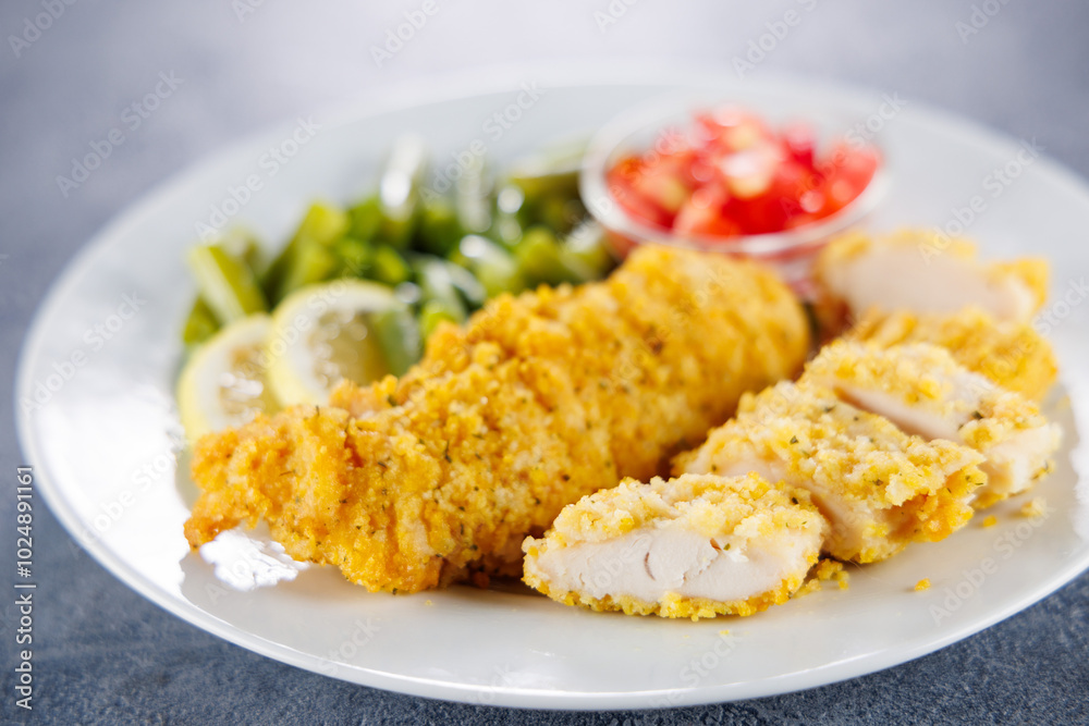 crispy fried chicken fillet with salad