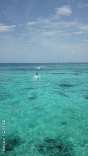 Vertical Aerial view of Boat ryding in Tankah Bay, Tulum, Mexican Caribbean photo