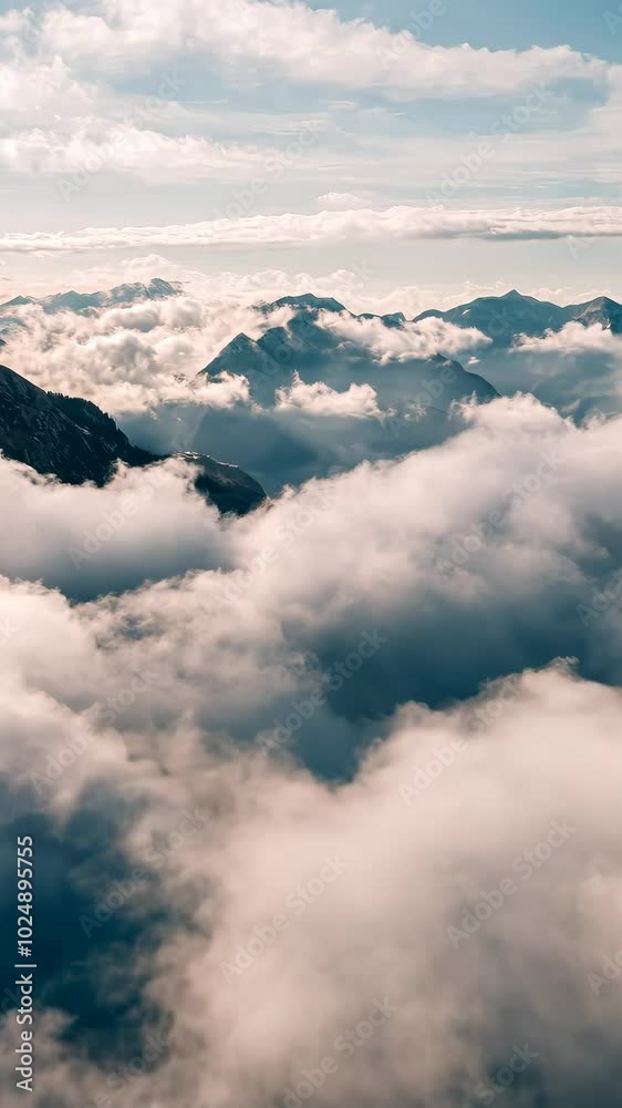 Mountain peaks emerging through clouds, aerial Mountain peaks emerging through clouds, aerial