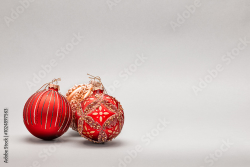 Christmas decoration, christmas ornaments - red and gold on gray background