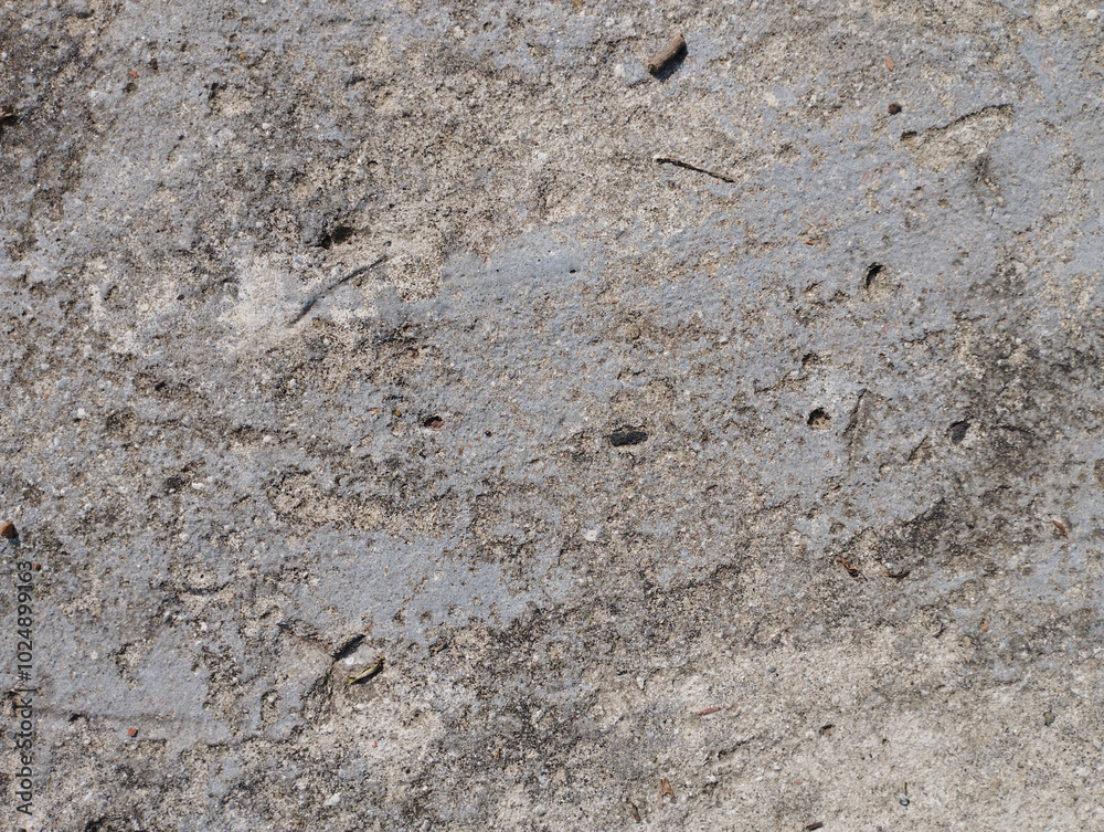 Close-up textured image of rough, cracked concrete surface with visible grainy details, ideal for backgrounds or construction themes Close-up textured image of rough, cracked concrete surface with visible grainy details, ideal for backgrounds or construction themes