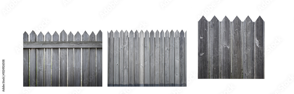 Fototapeta premium Gray wooden fence with pointed tops, viewed from the side.