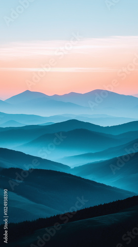 Foggy Blue Mountain Ranges at Sunrise – Serene Nature Landscape with Soft Pink and Blue Tones