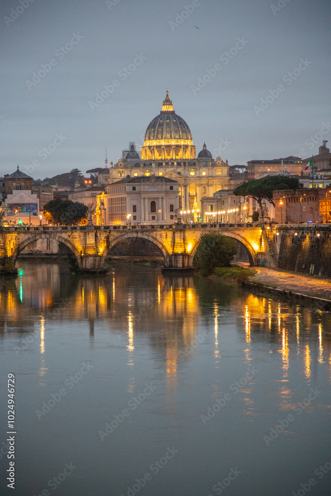 View over the Tiber River in a historic city. The old well-known bridge Ponte Sant'Angelo, in the evening. Rainy weather at sunset and view of the Basilica di San Pietro, Rome, Italy View over the Tiber River in a historic city. The old well-known bridge Ponte Sant'Angelo, in the evening. Rainy weather at sunset and view of the Basilica di San Pietro, Rome, Italy