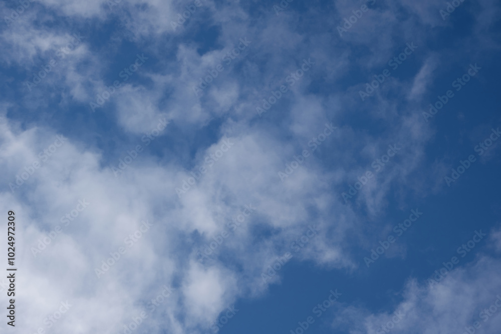 View of the sky with scattered white clouds. Concept of leisure, calm and peace View of the sky with scattered white clouds. Concept of leisure, calm and peace