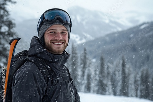 Man wearing a black jacket and a hat is smiling and posing for a picture. He is holding a pair of skis and a backpack. Concept of adventure and excitement. Social media photo of a man skiing