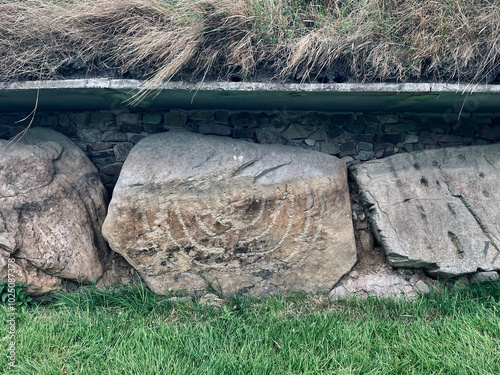 Fels mit eingraviertem Muster an einem jungsteinzeitlichen Ganggrab in Knowth im UNESCO Weltkulturerbe Brú na Bóinne, Irland photo