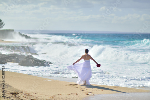 Beautiful young woman with long hair, A bride near the ocean photo