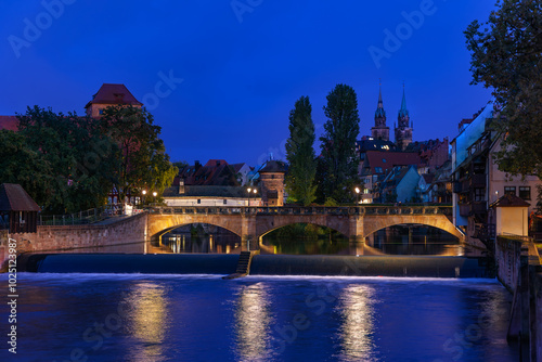 The ancientstone Max Bridge in the old town, viewed from Kettensteg at night, Nueremberg, Germany photo