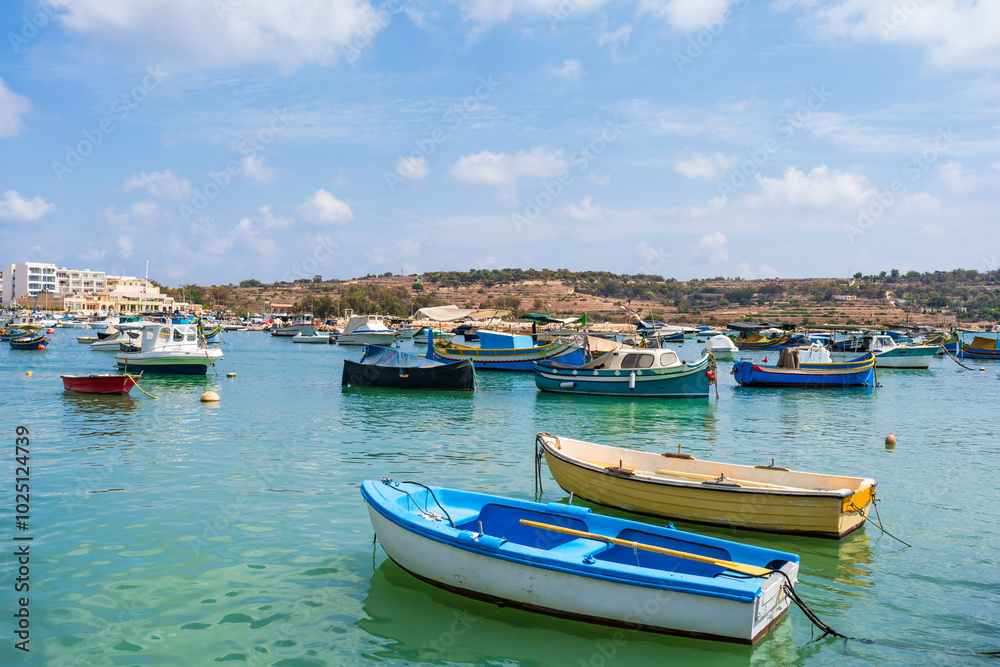 View of Marsaxlokk harbour with traditional colourful fishing boats in Malta View of Marsaxlokk harbour with traditional colourful fishing boats in Malta