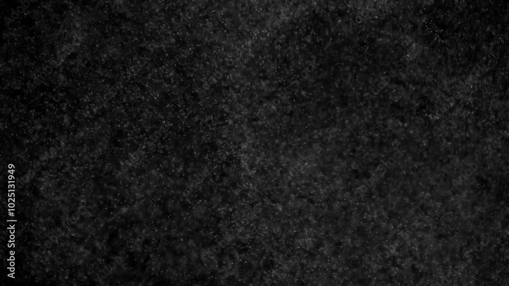 Swirling Small Particles. Small white particles flow in the air on a black background. Slow Motion Swirling Small Particles. Small white particles flow in the air on a black background. Slow Motion