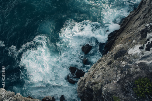 Aerial view of crashing waves on cliffs