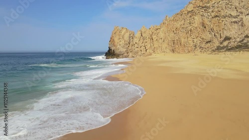 Wallpaper Mural Aerial drone footage of a white sand beach with crashing ocean waves and rock cliffs in the bacjground on a clear summer day Torontodigital.ca