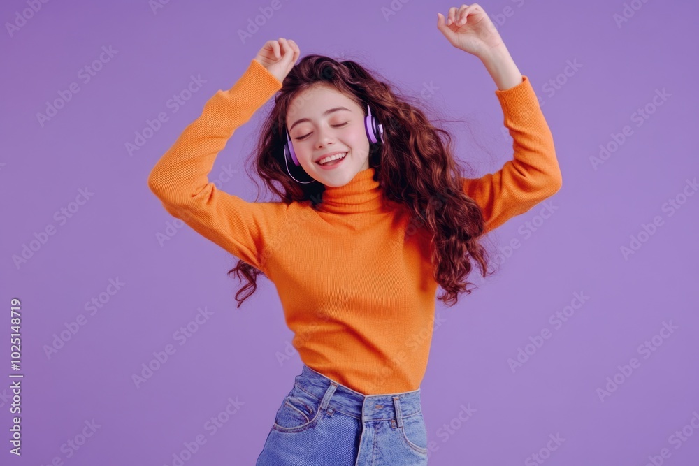 A woman in an orange turtle neck sweater and jeans dancing, perfect for music or dance related uses A woman in an orange turtle neck sweater and jeans dancing, perfect for music or dance related uses