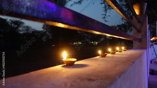 Oil lamps lit on colorful rangoli during diwali celebration, Rangoli with diyas. Diwali is a festival of lights celebrations by Hindus , Jains, Sikhs and some Buddhists photo