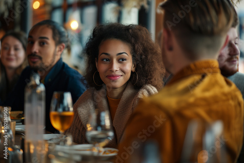 Friends enjoying food together at a restaurant in a diverse group