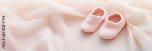 A pair of tiny pastel baby boots rests on soft, neutral fabric, symbolizing the fragility and hope of premature births, bathed in warm light that evokes care and resilience.