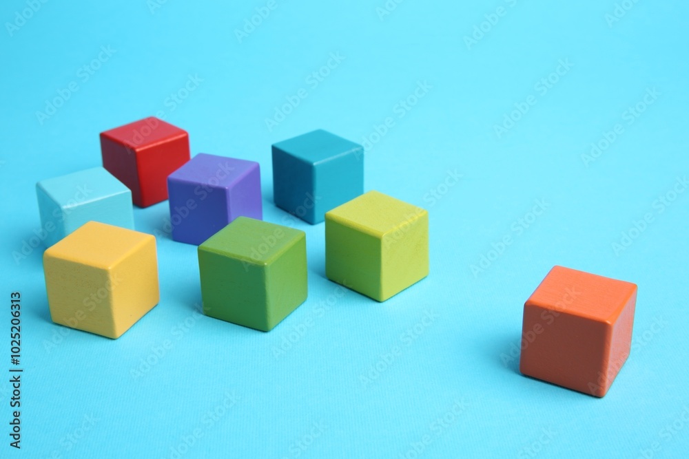 Many colorful cubes on light blue background Many colorful cubes on light blue background