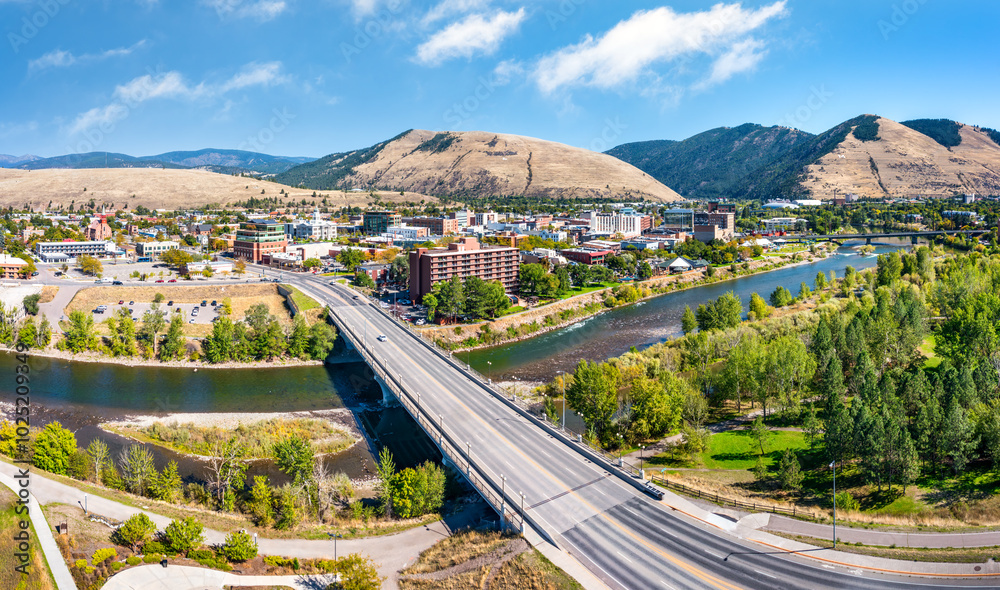 Aerial panorama of Missoula, Montana, above Beartracks Bridge. Missoula is a city in and the county seat of Missoula County, Montana. It is located along the Clark Fork River.