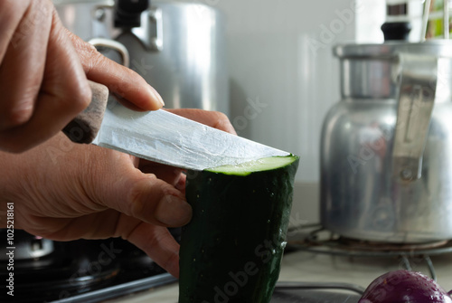 Close-up of a woman's hands cutting vegetables with a knife on a cutting board. Home cooking concept, gastronomy, veganism.
