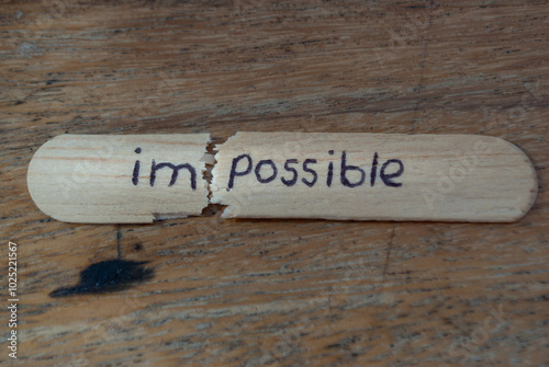 wooden sticks with impossible text on a wooden background, concept of improvement