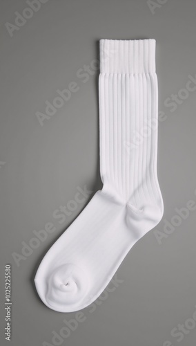 A close-up image featuring white socks against a gray backdrop