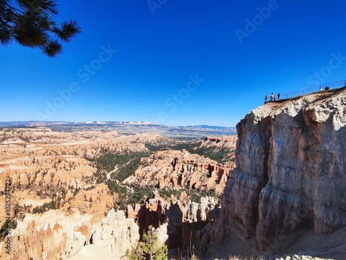 bryce canyon panorama at noon, from nearby the highest cliff, people silhouette on the cliff