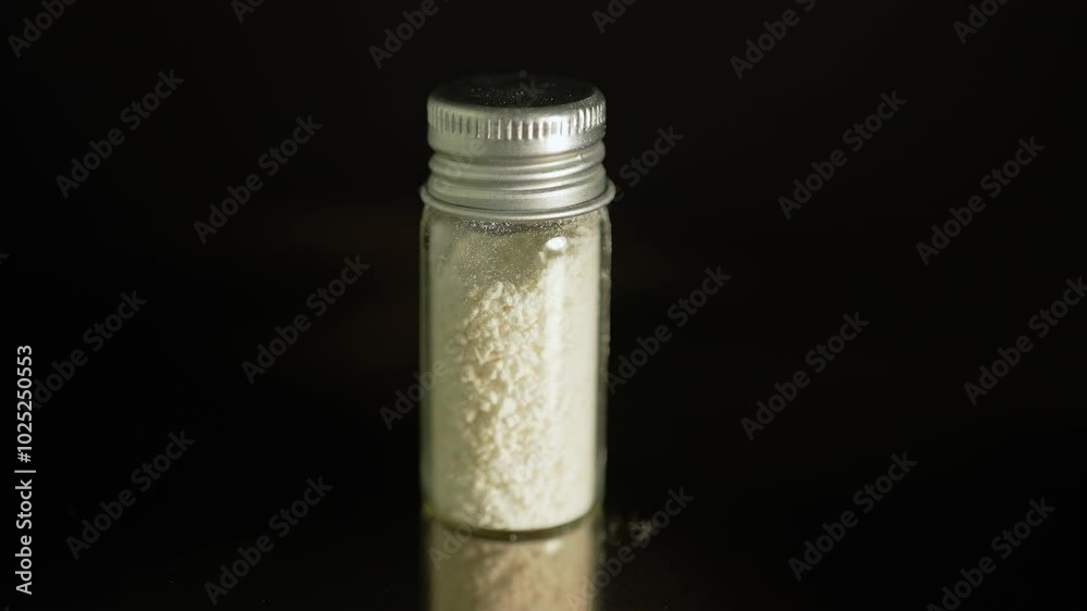 Powdered illegal drugs stored in a glass vial, indicating substance abuse. Ongoing crisis involving opioids and fentanyl. Heroin or crushed oxycodone placed in a container. Powdered illegal drugs stored in a glass vial, indicating substance abuse. Ongoing crisis involving opioids and fentanyl. Heroin or crushed oxycodone placed in a container.