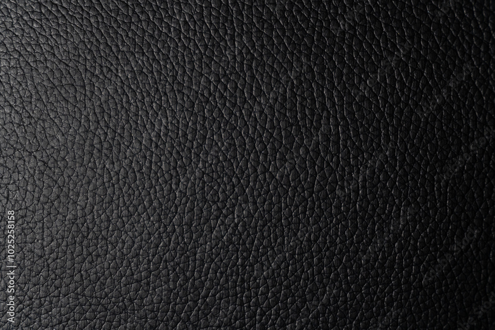 A close-up of a smooth black faux leather surface. A monochrome texture of smooth black faux leather with minimal textural details. This material is perfect for modern and stylish products. A close-up of a smooth black faux leather surface. A monochrome texture of smooth black faux leather with minimal textural details. This material is perfect for modern and stylish products.