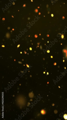 Vertical Golden Showers Abstract Background 4K Loop features golden glowing coins or confetti falling against a black background in a vertical ratio loop.