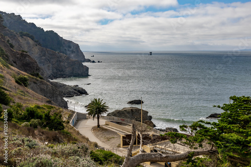 Canvas Print Breathtaking coastal view from China Beach, San Francisco, showcasing rugged cliffs and the Pacific Ocean under a partly cloudy sky