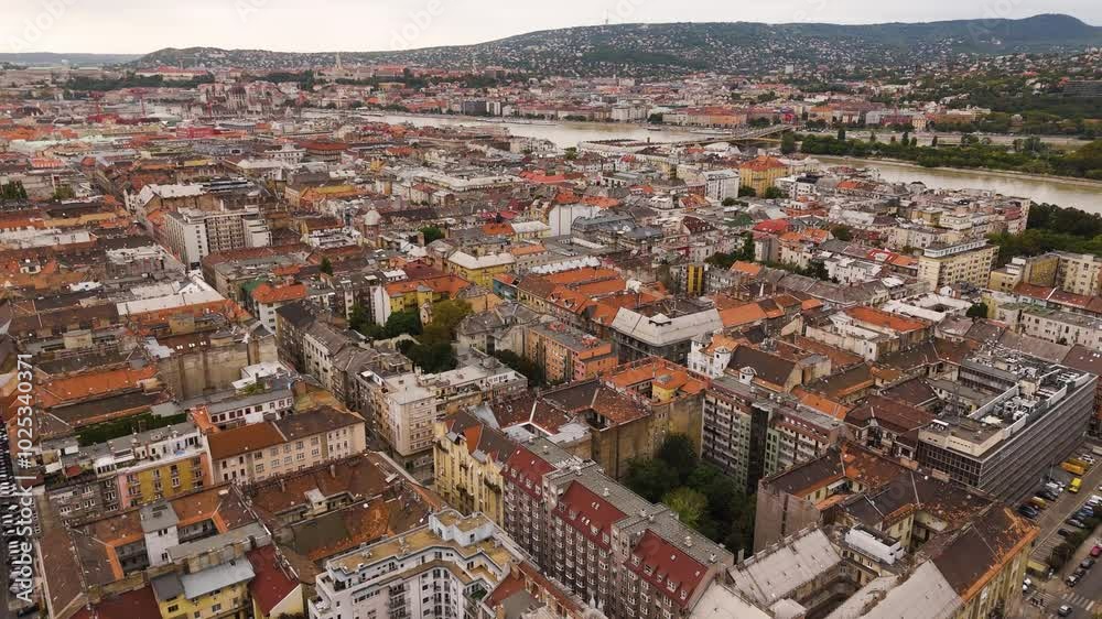 Budapest, Hungary aerial view streets old city of in summer in cloudy weather. Red roofs, cozy city streets with a lot of cars. Top cinematic aerial view. Budapest aerial. Budapest, Hungary aerial view streets old city of in summer in cloudy weather. Red roofs, cozy city streets with a lot of cars. Top cinematic aerial view. Budapest aerial.