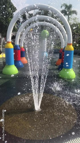 Fountain equipment in children's water park during summer holidays in the morning with bright blue sky background