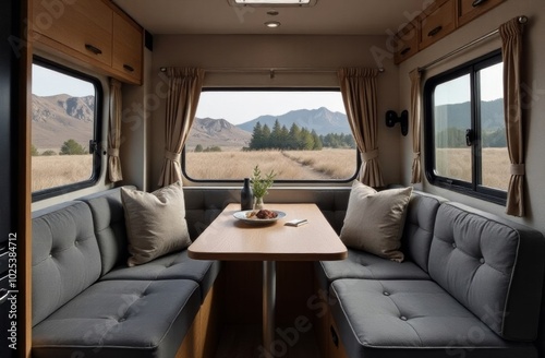 Cozy interior of a modern camper van with scenic mountain views in the background during daytime