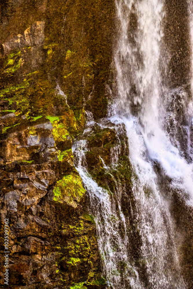 Water and moss interplay on rocky waterfall. Water and moss interplay on rocky waterfall.