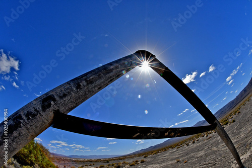 Toppled water-well pipes from bygone era and sunburst  photo