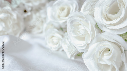 Close-up image of delicate white fabric roses on a smooth white surface. Modern photos with beautiful and soft color tones for banners and posters.