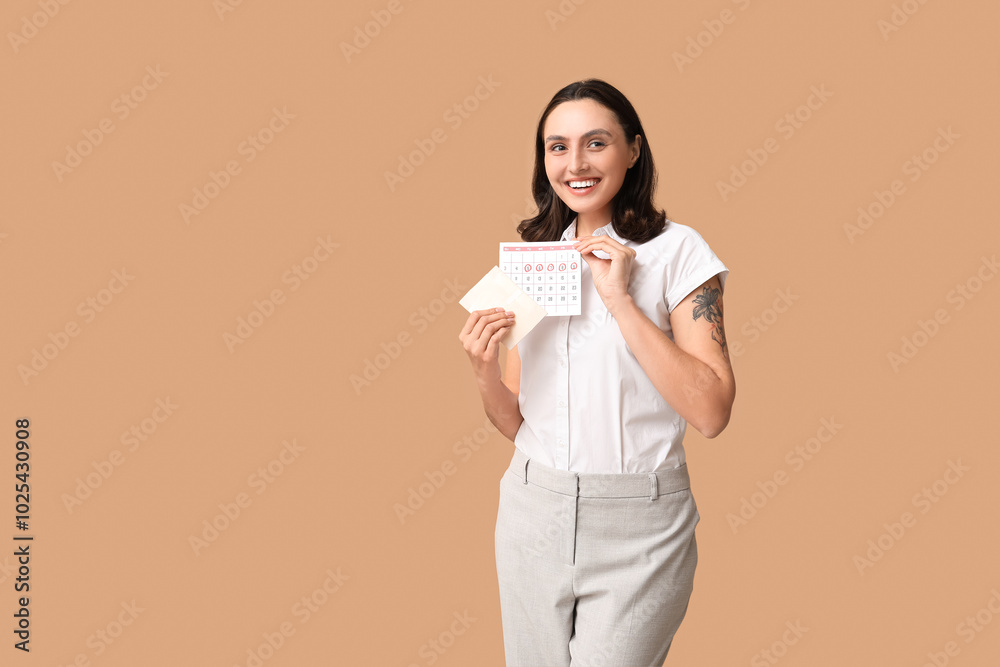 Beautiful young woman holding pad and calendar with marked days of menstruation on brown background Beautiful young woman holding pad and calendar with marked days of menstruation on brown background