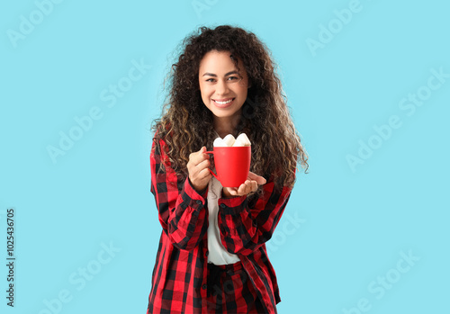 Smiling young woman holding...