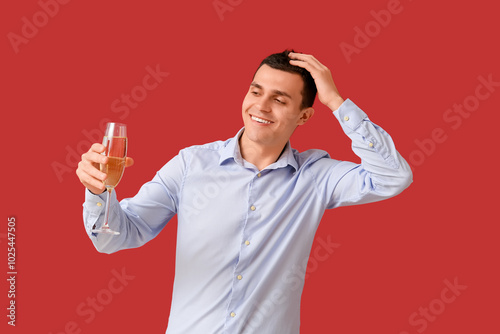 Happy young man with glass ...