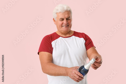 Senior man with bottle of c...
