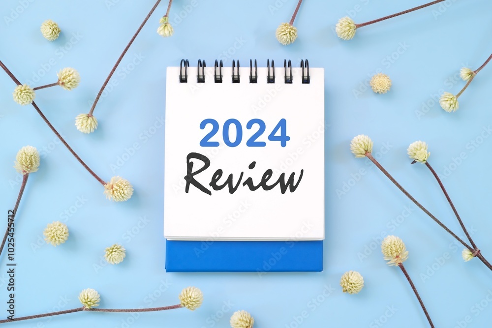 2024 year in review concept. Note typography in blue background flat lay.