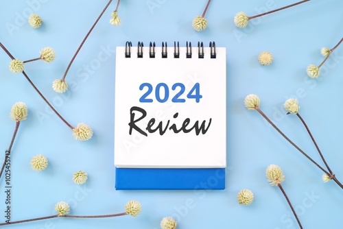 Obraz na płótnie 2024 year in review concept. Note typography in blue background flat lay. w salonie