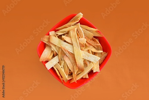 Spicy masala Tapioca Chips Keripik Sinhkong or Cassava chips with Indian Tea, Popular snacks in India, Kerala, top view, delicious crispy snack food spiced cassava photo