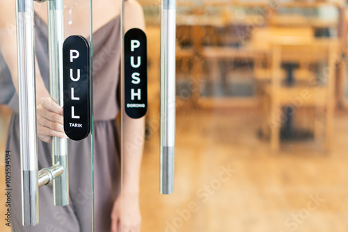 Woman Interacting with Glass Doors in a Cafe