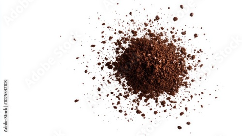 A pile of ground coffee on a white background, with a few grains scattered around it.