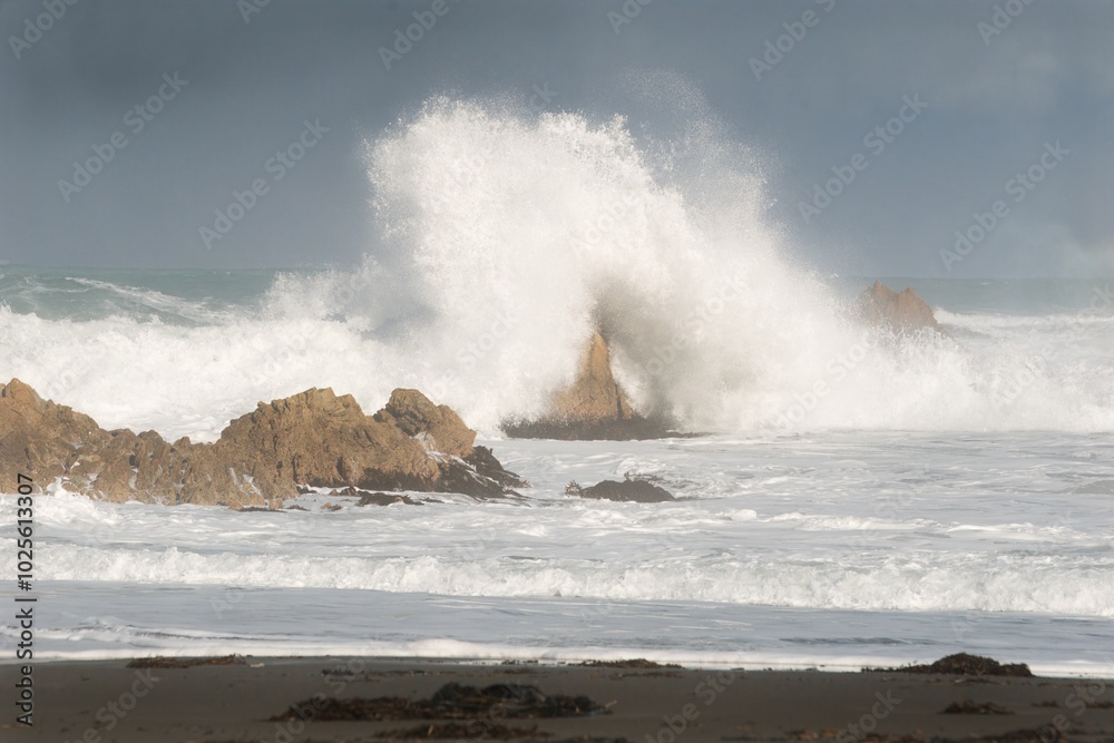 Waves Heavily Crashing on Coastal Rocks - Dramatic Seaside Action Waves Heavily Crashing on Coastal Rocks - Dramatic Seaside Action