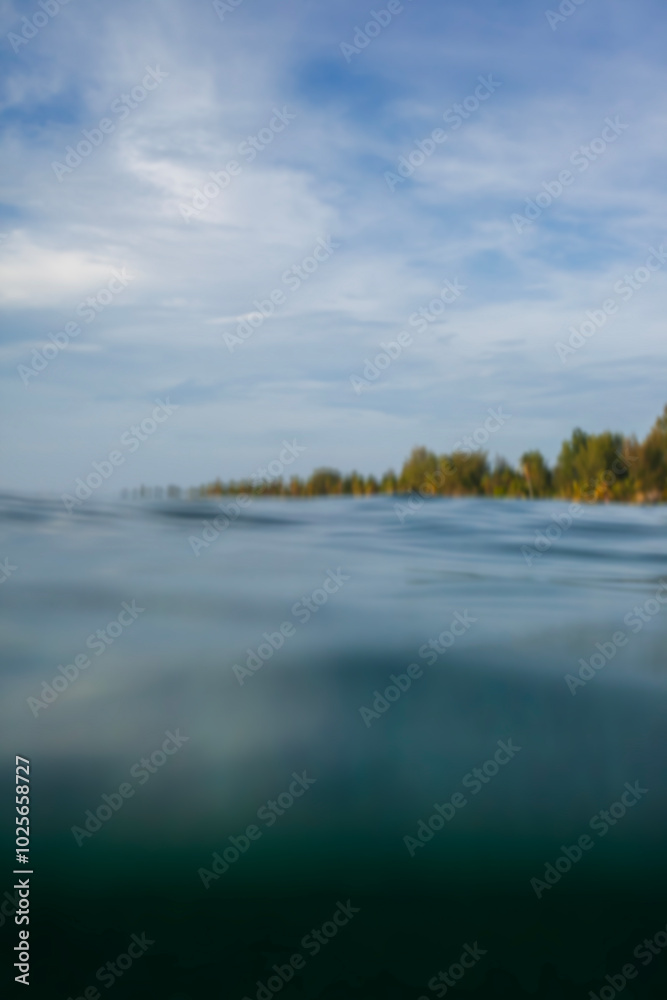Beautiful blurred tropical beach background, beach seen from sea level. Photographed out of focus, to get blur effect for background design. Beautiful blurred tropical beach background, beach seen from sea level. Photographed out of focus, to get blur effect for background design.